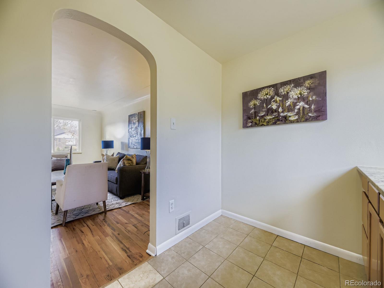 3820 Pierce Street Wheat Ridge, CO 80033 - Photo 14 of 32 a bed room with a bed and a view of en suite bathroom