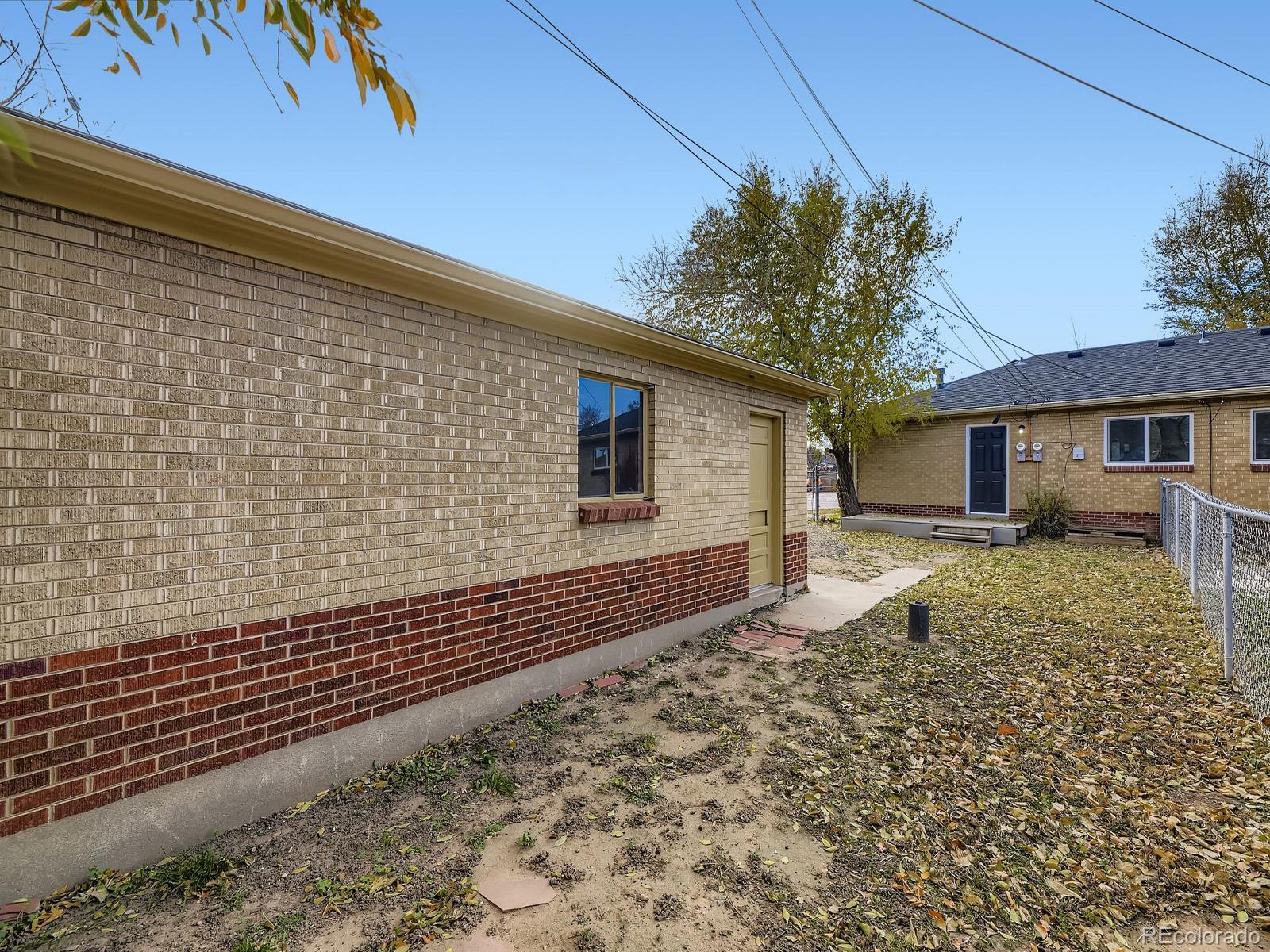 3820 Pierce Street Wheat Ridge, CO 80033 - Photo 29 of 32 a front view of a house with a yard
