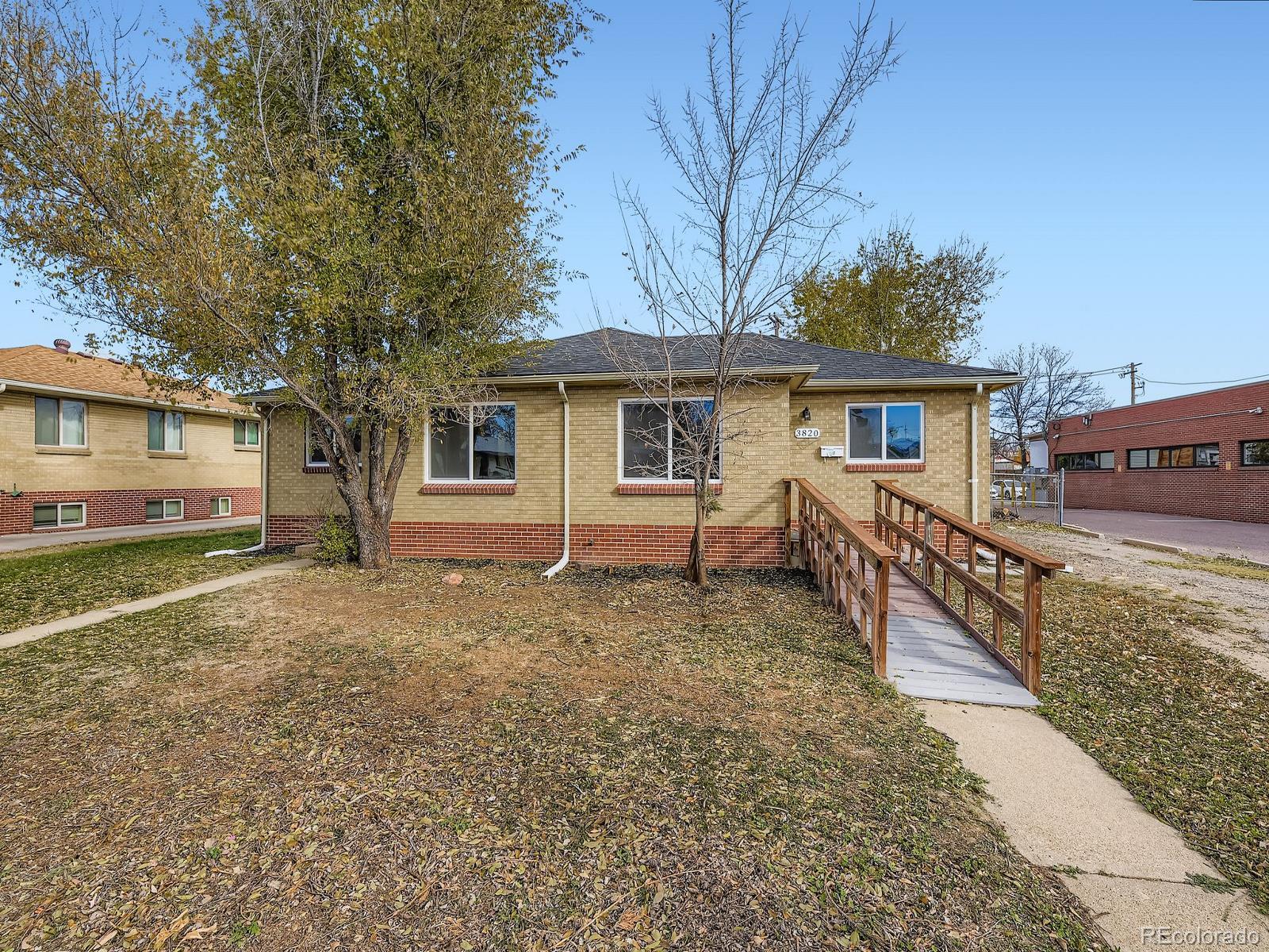 3820 Pierce Street Wheat Ridge, CO 80033 - Photo 3 of 32 a house with trees in front of it