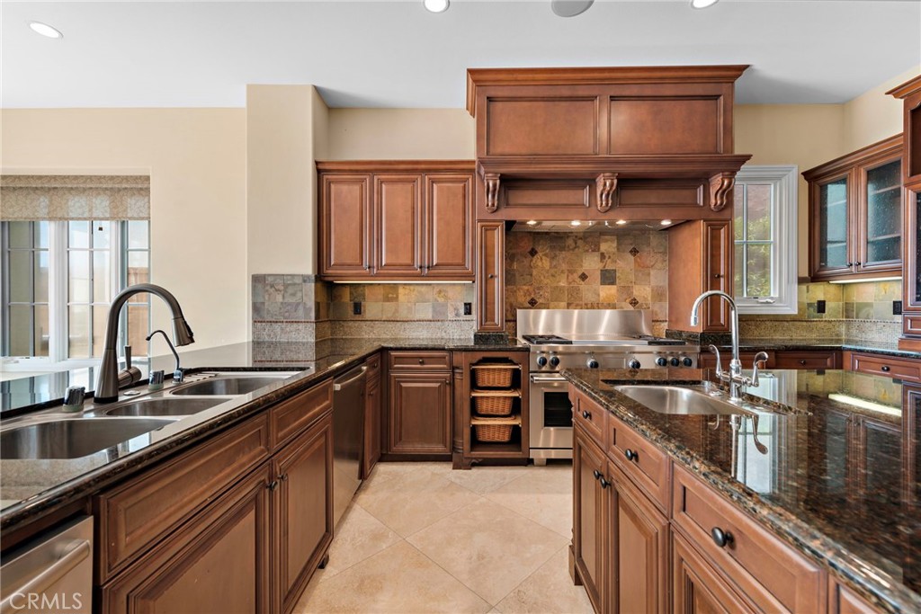 27 Pacific Mist Newport Coast, CA 92657 - Photo 13 of 44 a kitchen with stainless steel appliances granite countertop a sink stove and cabinets