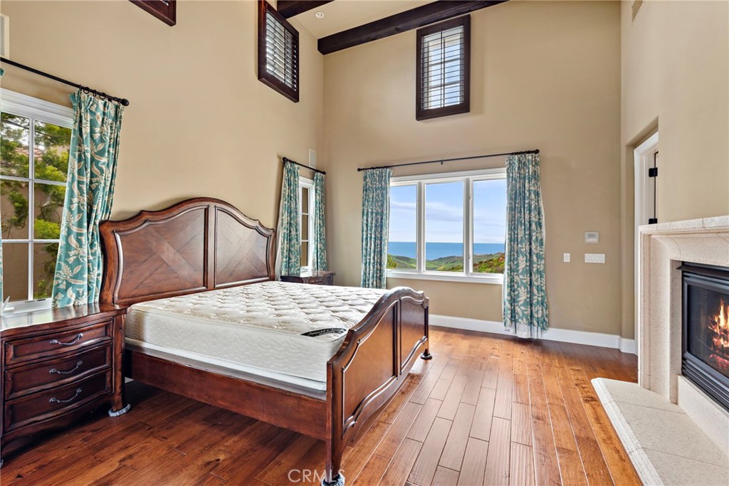 27 Pacific Mist Newport Coast, CA 92657 - Photo 29 of 44 a bedroom with a bed and a large window