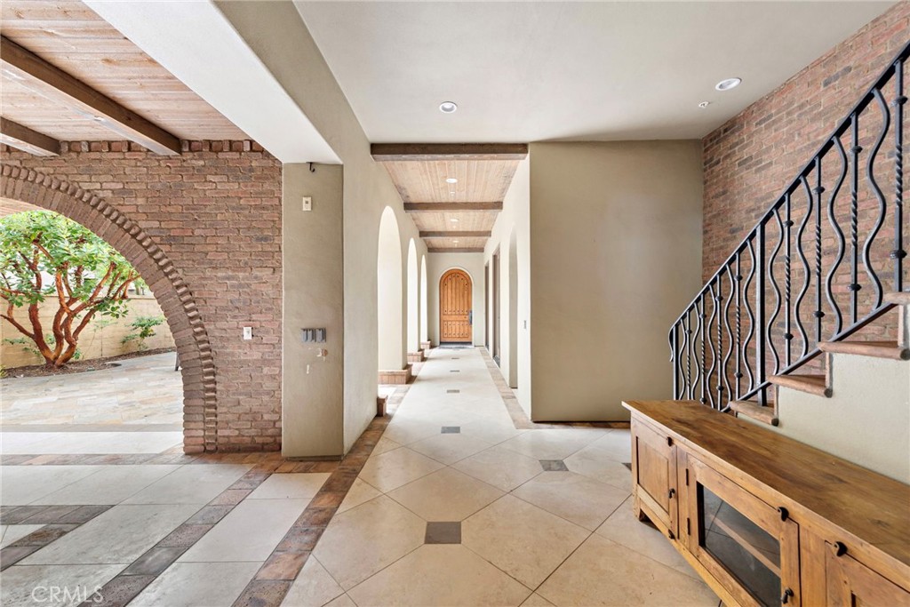 27 Pacific Mist Newport Coast, CA 92657 - Photo 3 of 44 a view of a hallway with entryway wooden floor and front door