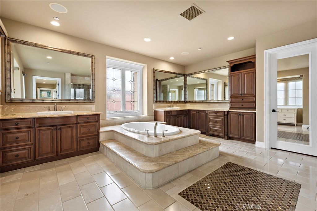 27 Pacific Mist Newport Coast, CA 92657 - Photo 31 of 44 a spacious bathroom with a granite countertop sink and a bathtub