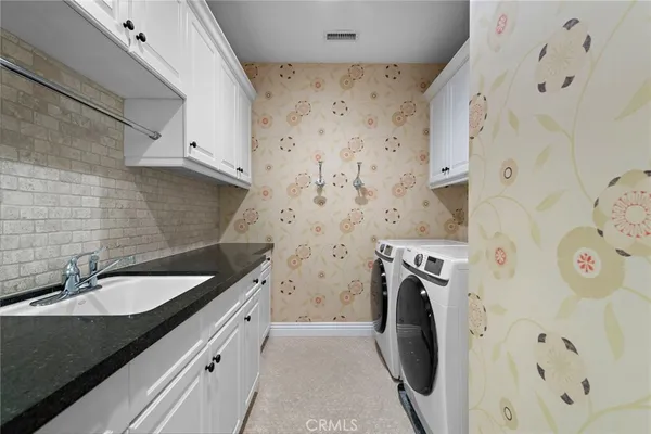 a bathroom with a sink and a washer dryer