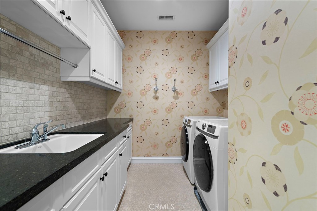 27 Pacific Mist Newport Coast, CA 92657 - Photo 35 of 44 a bathroom with a sink and a washer dryer