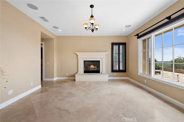 wooden floor fireplace and windows in an empty room