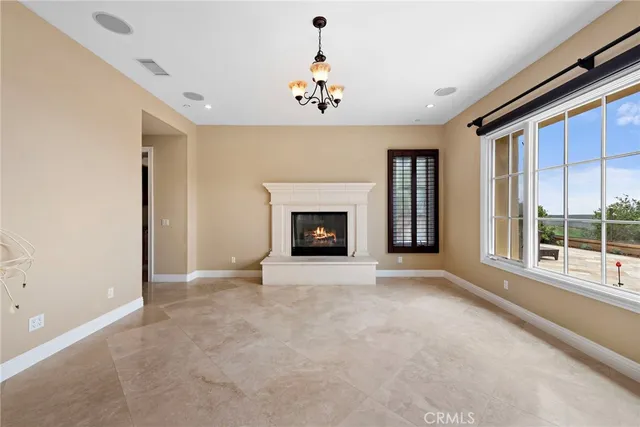 wooden floor fireplace and windows in an empty room