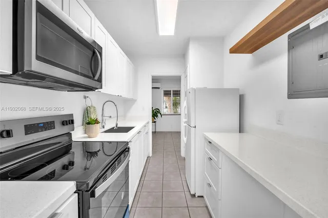 a kitchen with a sink stainless steel appliances and cabinets