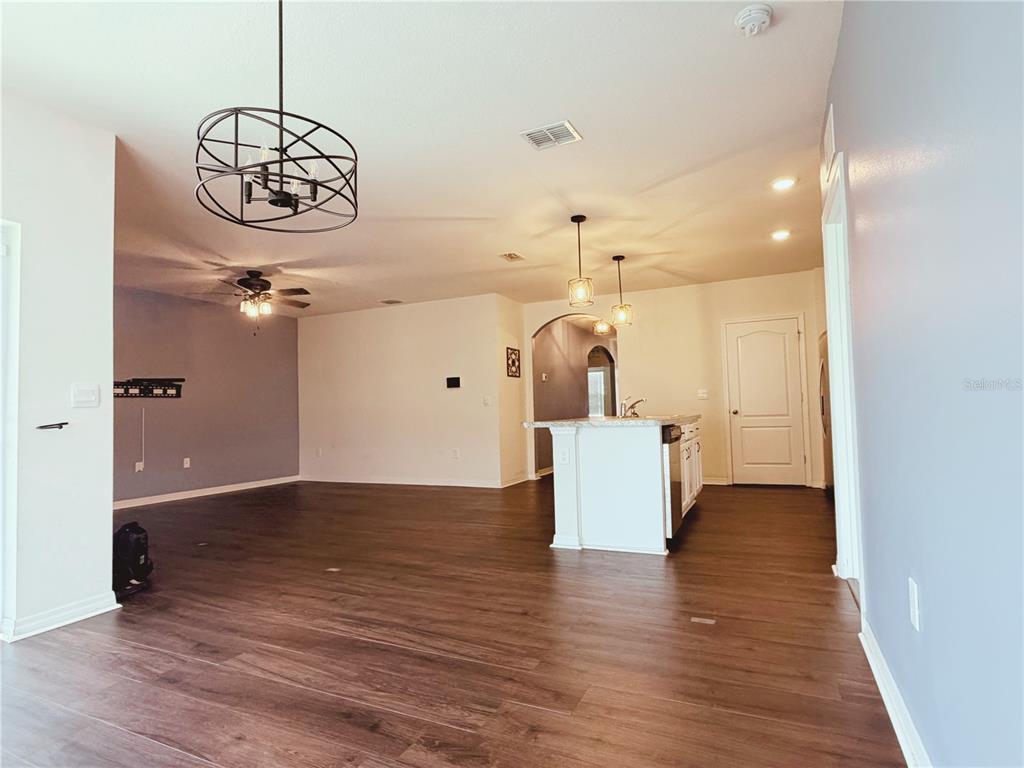 910 Sun Burst Road Winter Haven, FL 33880 - Photo 3 of 14 a view of a hallway with wooden floor