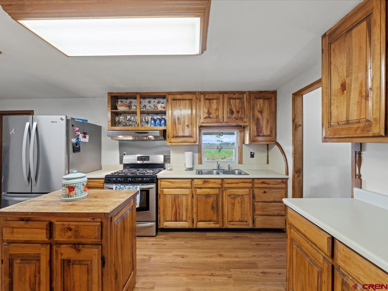 6910 High Mesa Road Olathe, CO 81425 - Photo 13 of 40 a kitchen with stainless steel appliances granite countertop a stove a sink dishwasher and a refrigerator