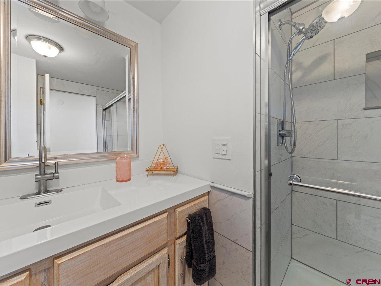 6910 High Mesa Road Olathe, CO 81425 - Photo 25 of 40 a bathroom with a sink and mirror