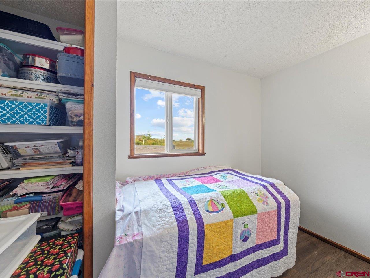 6910 High Mesa Road Olathe, CO 81425 - Photo 28 of 40 a bedroom with a bed and closet