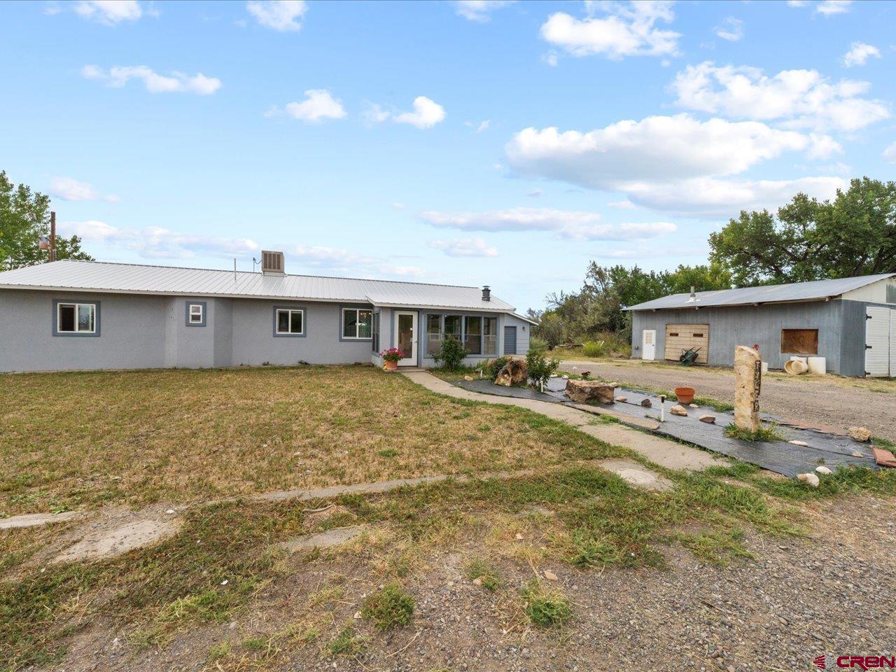 6910 High Mesa Road Olathe, CO 81425 - Photo 3 of 40 a front view of house with yard