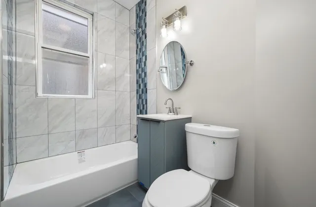 a bathroom with a toilet a sink and bathtub