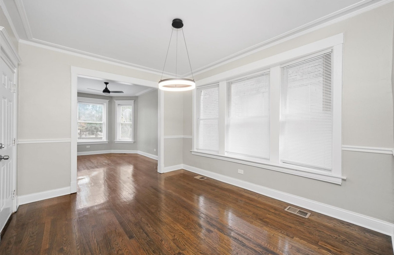 7548 South Harvard Avenue, Unit 2 Chicago, IL 60620 - Photo 5 of 7 a view of an empty room with wooden floor and a window