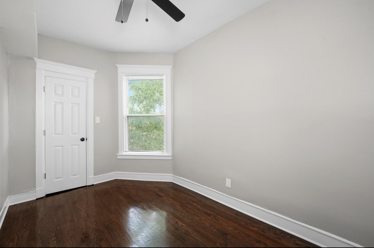 7548 South Harvard Avenue, Unit 2 Chicago, IL 60620 - Photo 6 of 7 an empty room with a window and wooden floor