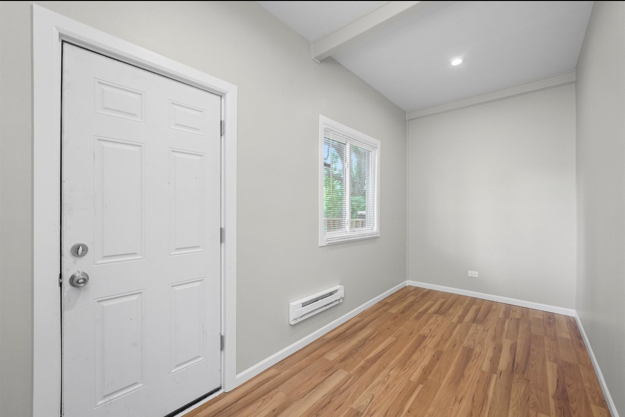 7548 South Harvard Avenue, Unit 2 Chicago, IL 60620 - Photo 7 of 7 a view of a room with wooden floor and windows