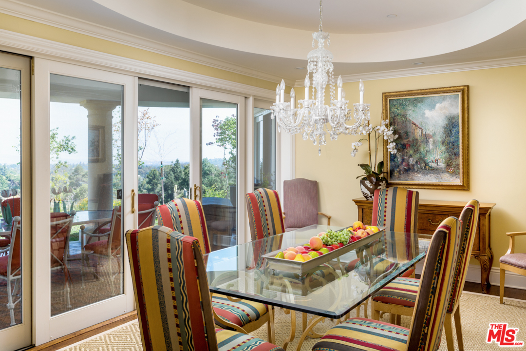 150 Patrician Way Pasadena, CA 91105 - Photo 12 of 43 a view of a dining room with furniture large windows and wooden floor