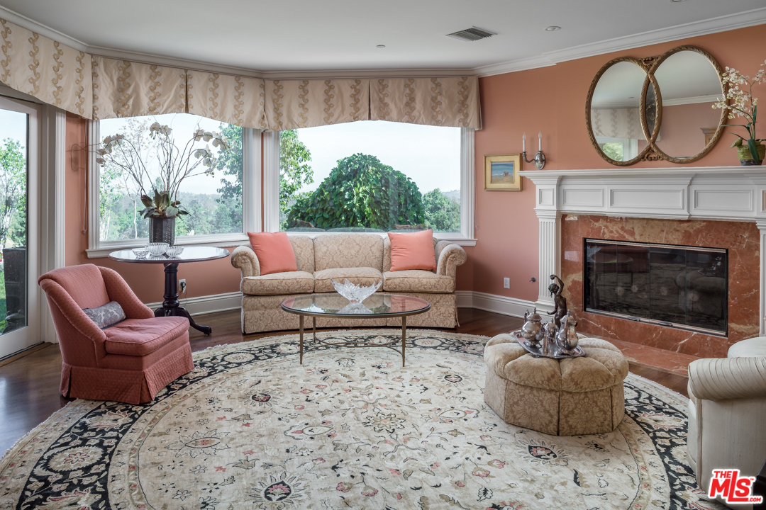 150 Patrician Way Pasadena, CA 91105 - Photo 14 of 43 a living room with furniture a fireplace and a large window