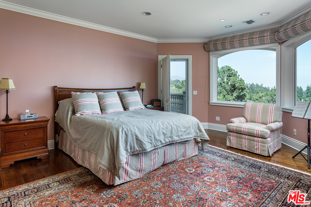 150 Patrician Way Pasadena, CA 91105 - Photo 18 of 43 a bedroom with a bed and wooden floor