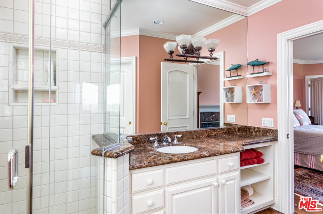 150 Patrician Way Pasadena, CA 91105 - Photo 19 of 43 a bathroom with a granite countertop sink and a mirror