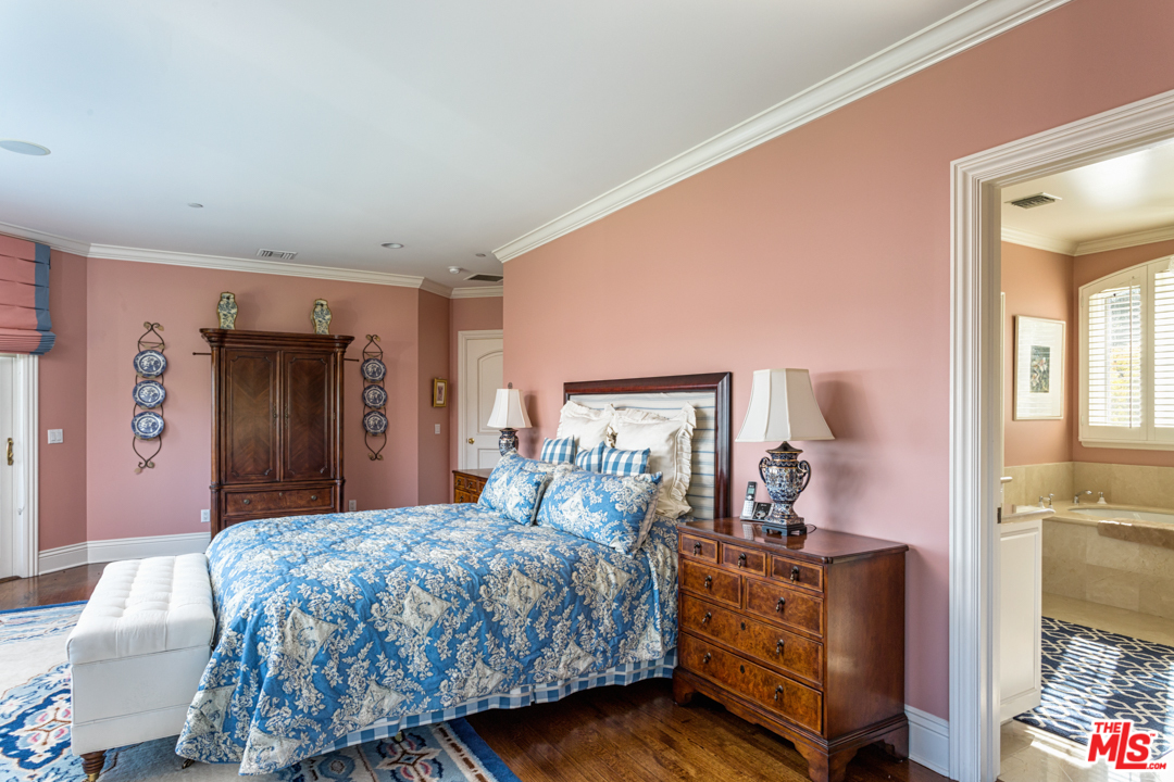 150 Patrician Way Pasadena, CA 91105 - Photo 29 of 43 a bedroom with a bed and wooden floor