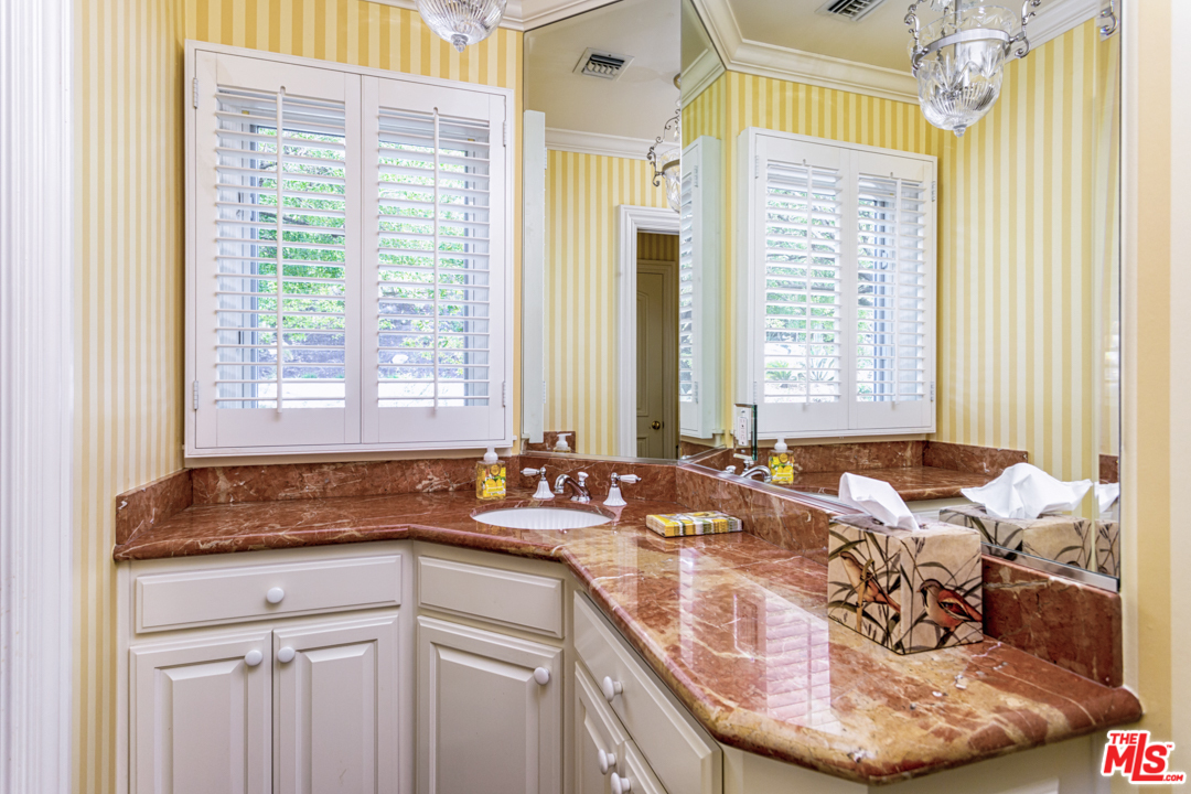 150 Patrician Way Pasadena, CA 91105 - Photo 5 of 43 a bathroom with a granite countertop sink and a mirror