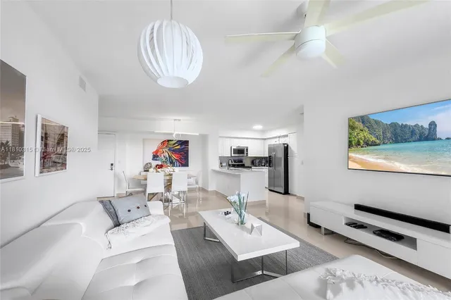 a white vase with white and yellow flowers