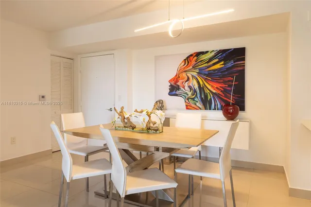 a view of a dining room with furniture and a potted plant