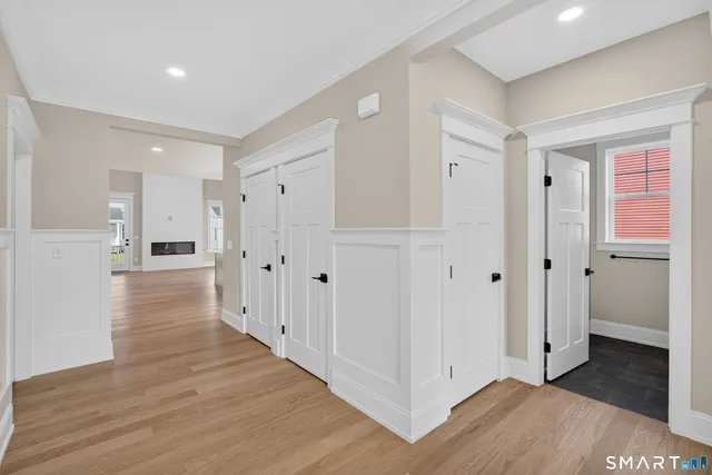 a view of a hallway with wooden floor and staircase