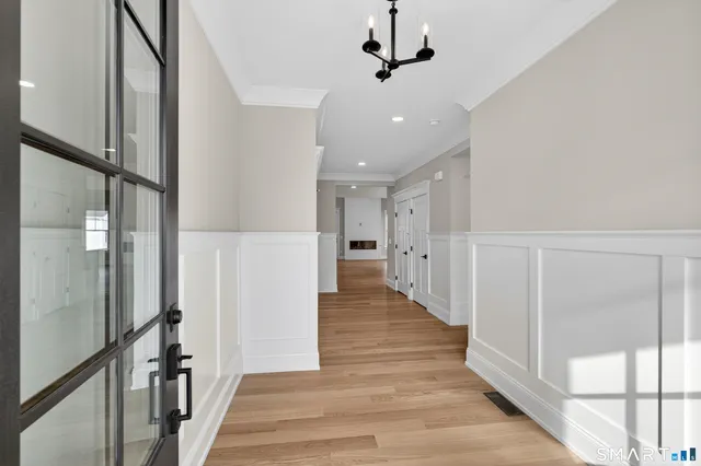 a view of a hallway with wooden floor