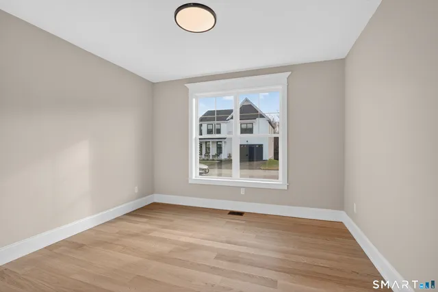 a view of an empty room and wooden floor