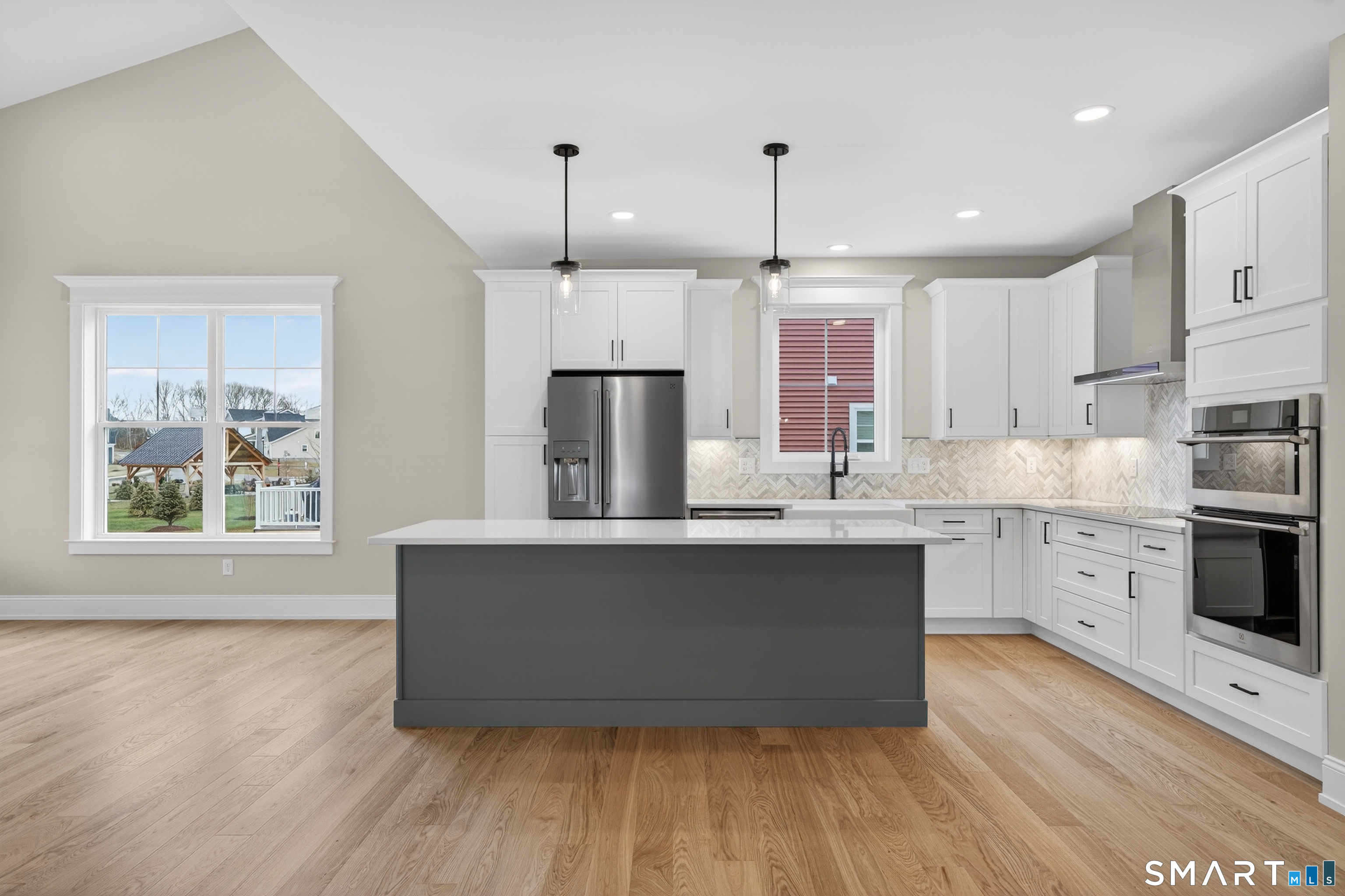 45 Summertime Circle Pawcatuck, CT 06379 - Photo 22 of 35 a kitchen with stainless steel appliances a kitchen island hardwood floor sink stove and wooden cabinets