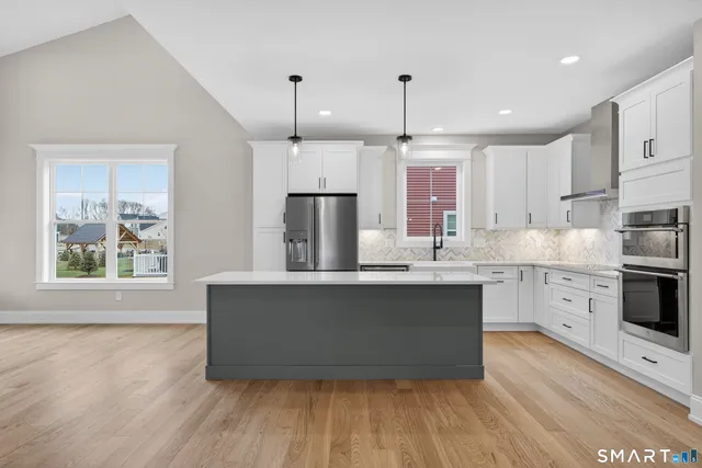 a view of a room with wooden floor and white walls