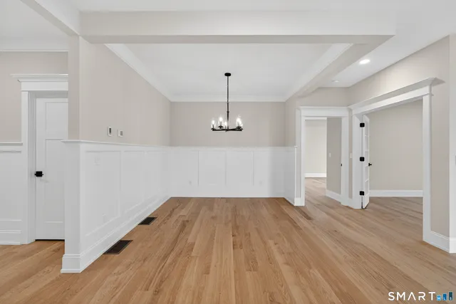 a view of a room with wooden floor and windows
