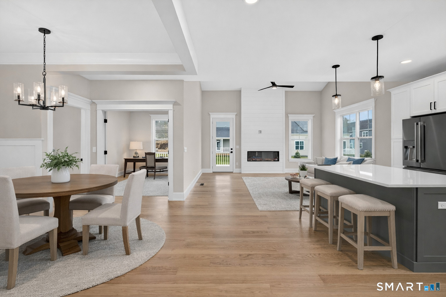 45 Summertime Circle Pawcatuck, CT 06379 - Photo 3 of 37 a view of a dining room and livingroom with furniture wooden floor a chandelier