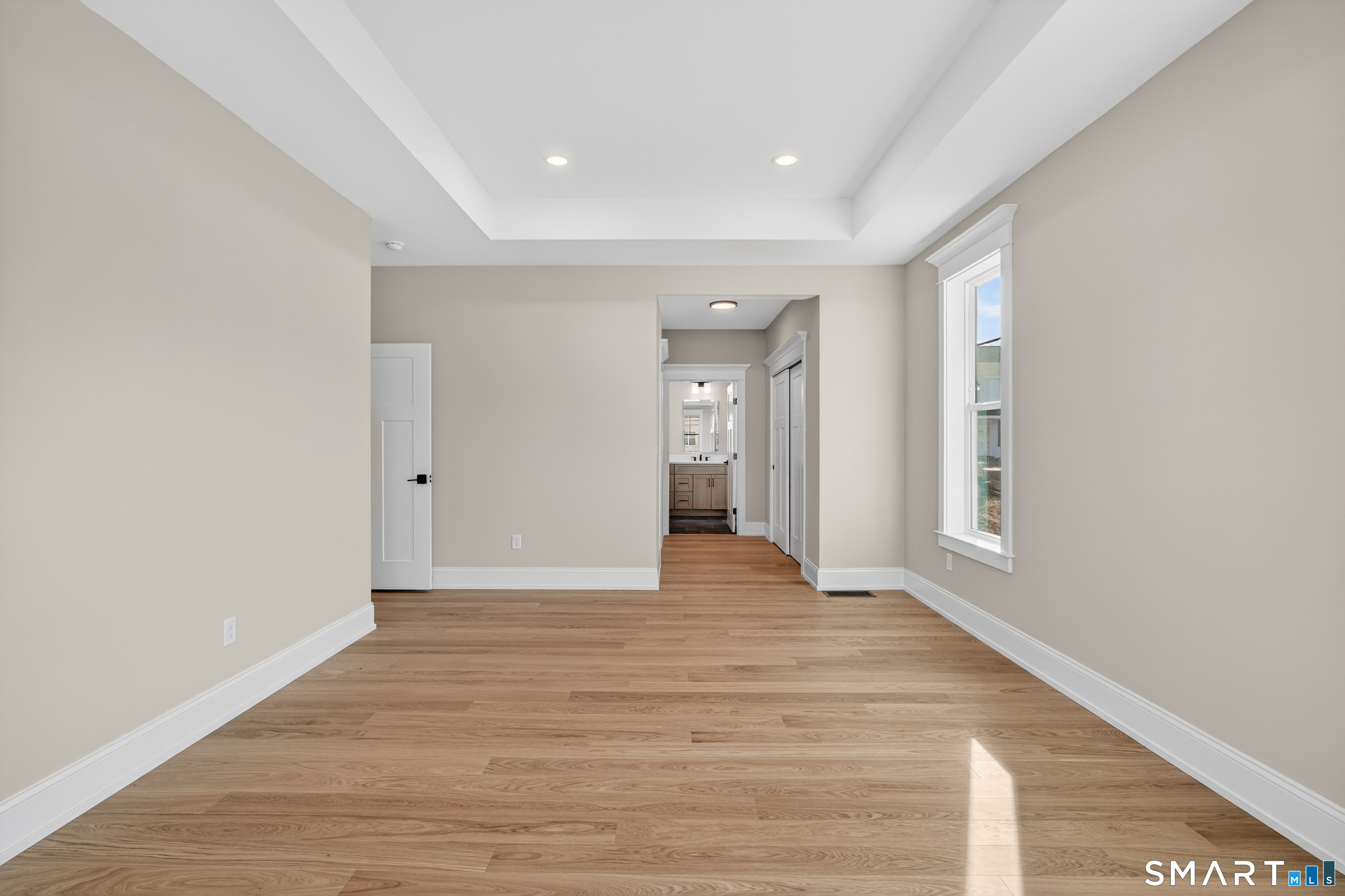 45 Summertime Circle Pawcatuck, CT 06379 - Photo 32 of 37 a view of an empty room with wooden floor and a window
