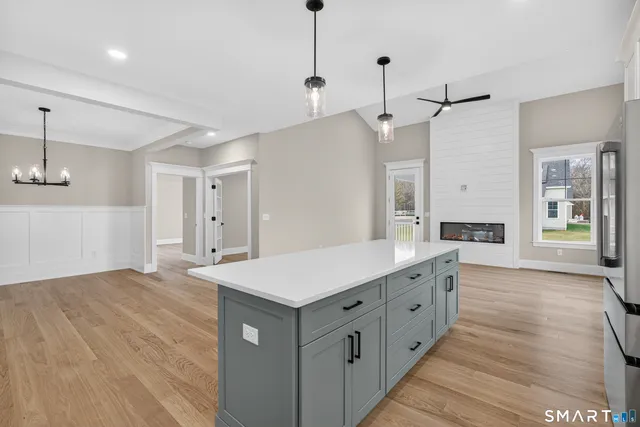 a large white kitchen with a sink a refrigerator and a stove