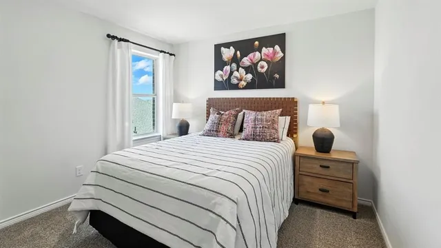 a bedroom with a bed and a painting on the wall