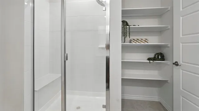 a view of walk in closet with empty racks