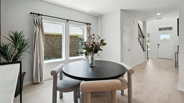 a dining room with furniture and wooden floor