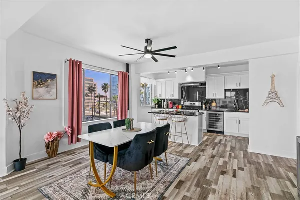 a kitchen with granite countertop a sink stove and refrigerator