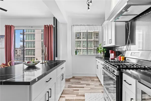 a kitchen that has a sink and a stove in it