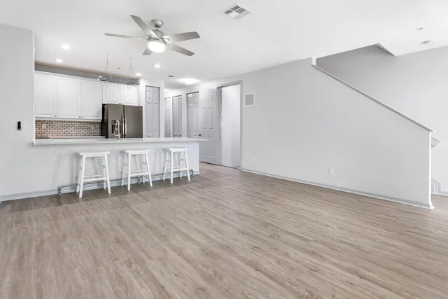 a dining room with wooden floor and furniture