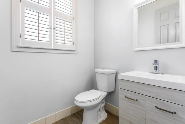 a white toilet sitting next to a bathroom sink