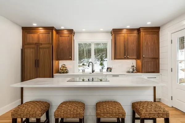 a large kitchen with a large window and stainless steel appliances