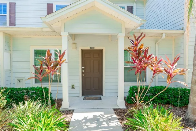 a couple of potted plants that are in front of door