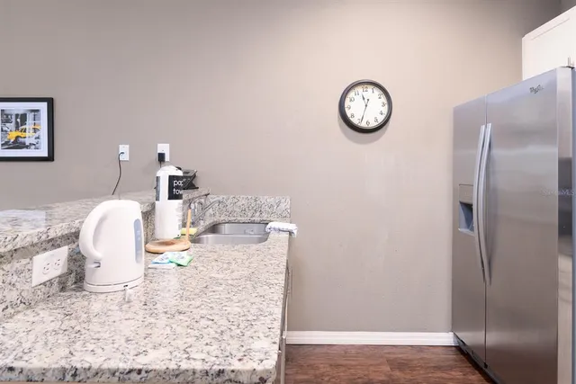 a kitchen with stainless steel appliances granite countertop a refrigerator stove and microwave