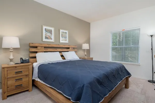 a bedroom with a bed and a night stand