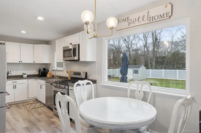 a kitchen with sink a window and cabinets